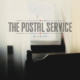 POSTAL SERVICE – GIVE UP (20TH ANNIVERSARY BLUE W/METALLIC SILVER) - LP •